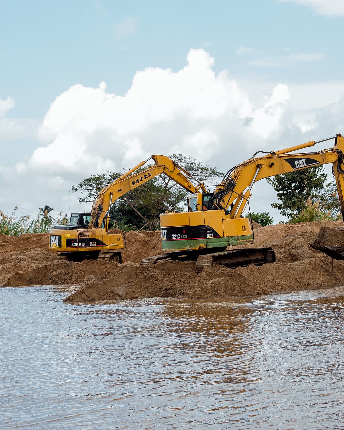 Two Ellyz excavators working on a riverbank earthworks site in Tanzania